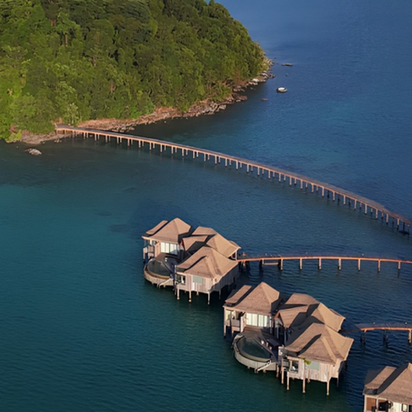 Tropical overwater resort villas connected by wooden walkways